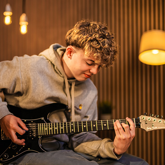 Kid learning on Harley Benton Guitar